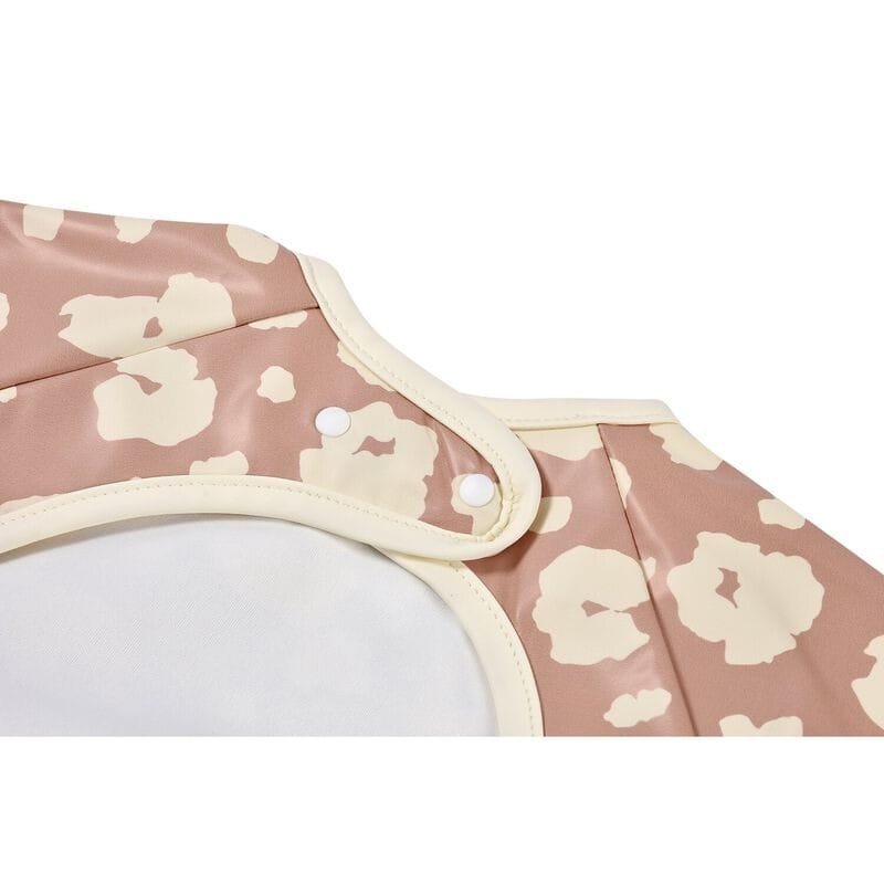 Bavoir Béaba "Savannah Bloom" à manches longues et détachables, poche récupératrice, réglable 3 tailles, imperméable, utilisable jusqu’à 4 ans, entretien facile.